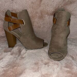 Featuring a peep-toe and cutouts at the ankle with a wraparound buckle strap